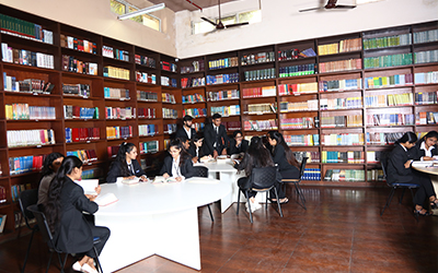 A group of students studying in the IMS Noida library, focusing on academic activities.