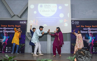 A student performing a dynamic dance routine at the Inter-Departmental Dance Competition at IMS Noida.