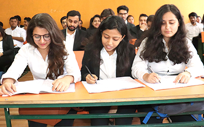 IMS Noida students engaged in learning during a classroom session.