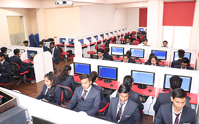 IMS Noida students working on computers in a well-equipped computer lab.